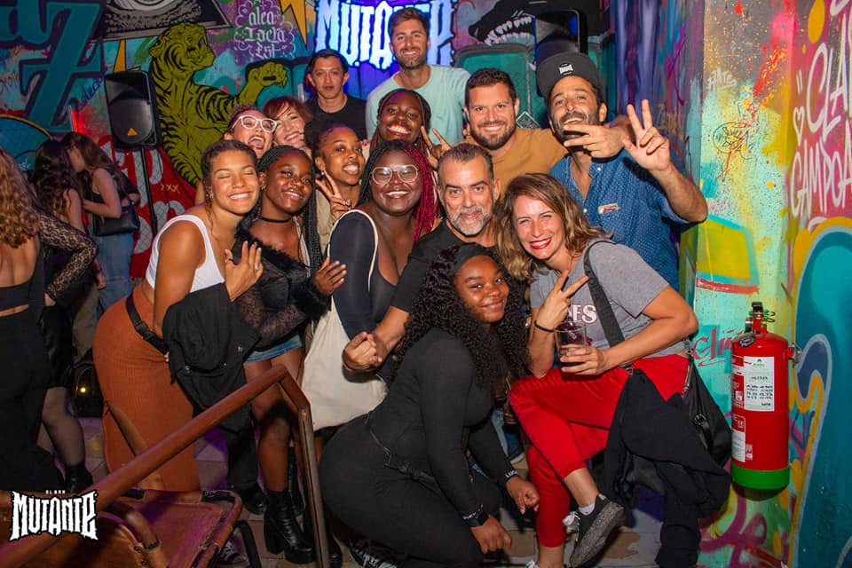 A group of friends posing together at night