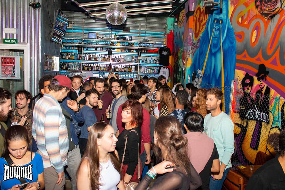 People chatting and mingling inside a lively venue